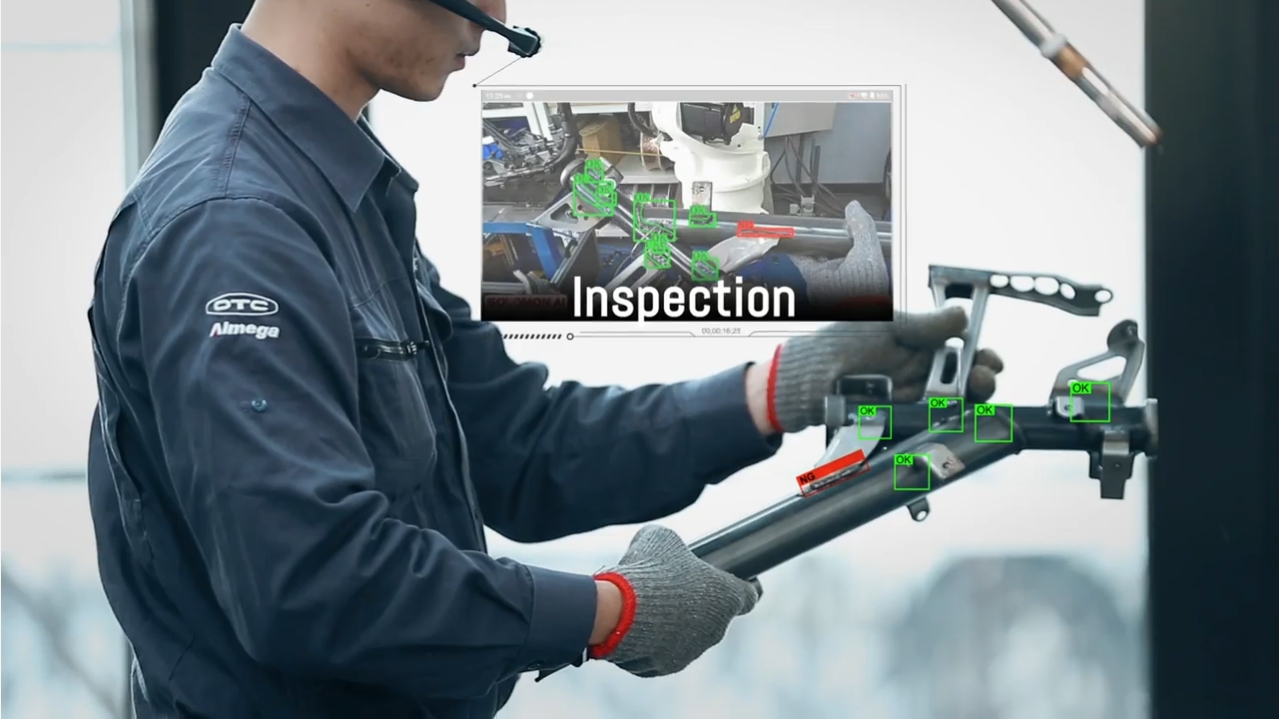 Welding Bead Defect Detection Using AR + AI 3 an engineer wearing a hardhat and AR glasses inspects a metal frame using META-aivi
