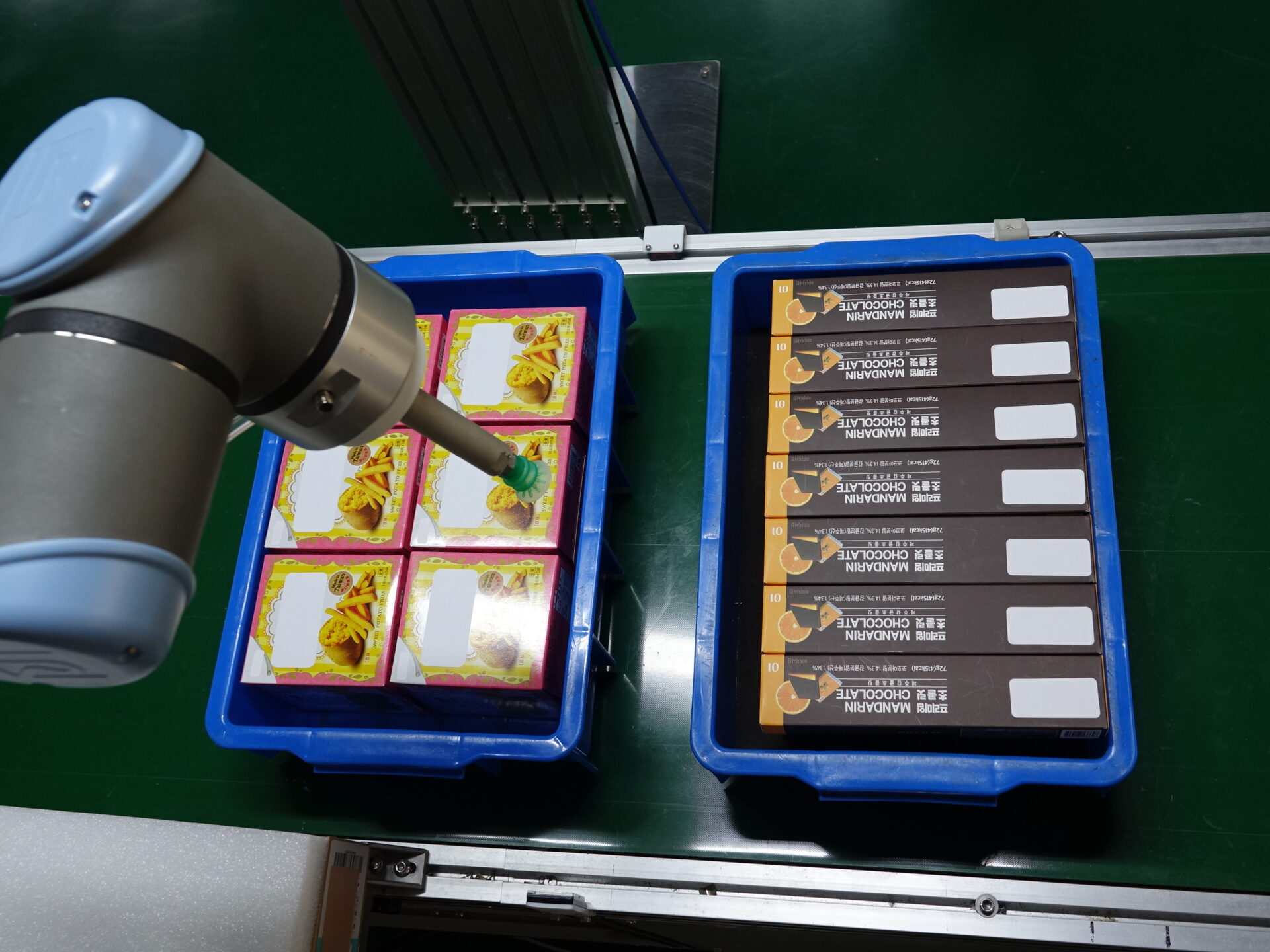 Order Fulfillment a UR robot arm picks tightly packed items from two bins on a conveyor
