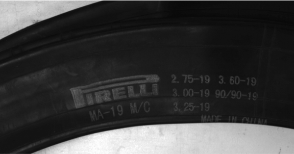 close up of a Pirelli tire Identification number (blurry text)