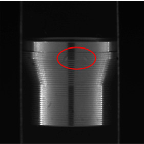 Automated AI inspection of a machined component with highlighted region indicating a detected surface defect.