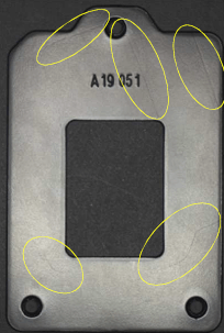An image of a metal casing with minor scratches and surface blemishes circled in yellow, showcasing the AI vision system's ability to classify defects.