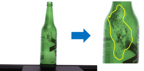 Surface Contamination Close-up of a returnable glass bottle with surface contamination highlighted.