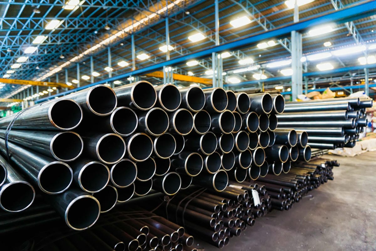 Stacked metal pipes high quality Galvanized steel pipe or Aluminum and chrome stainless pipes in stack waiting for shipment in warehouse