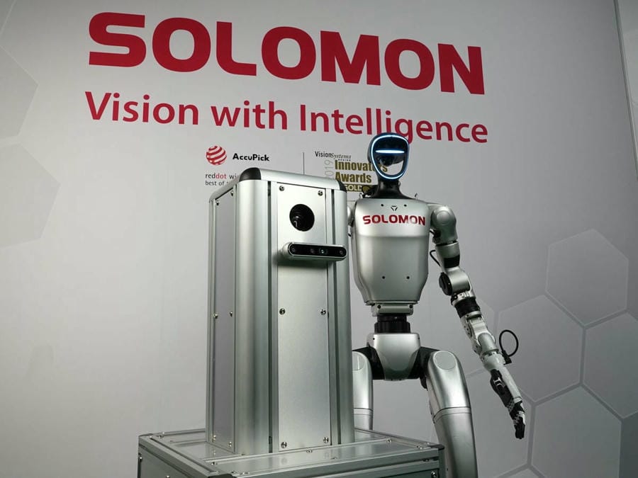 Sora x Supereye Humanoid Robot Solomon humanoid robot with AI vision and an AMR in front of the Solomon logo and slogan in a warehouse.