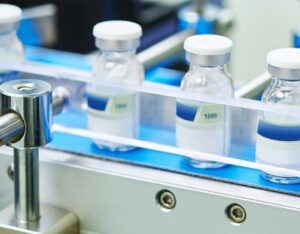 Automated pharmaceutical vial inspection detecting defects using SolVision AI vision system.