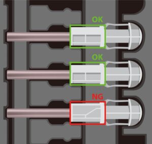SolVision AI inspection of safety-engineered needles showing conforming (OK) and non-conforming (NG) components.